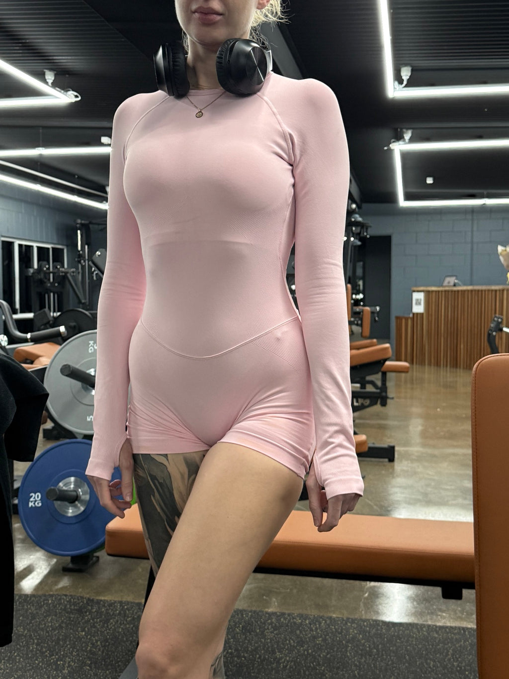 Light Pink bodysuit front view in the gym