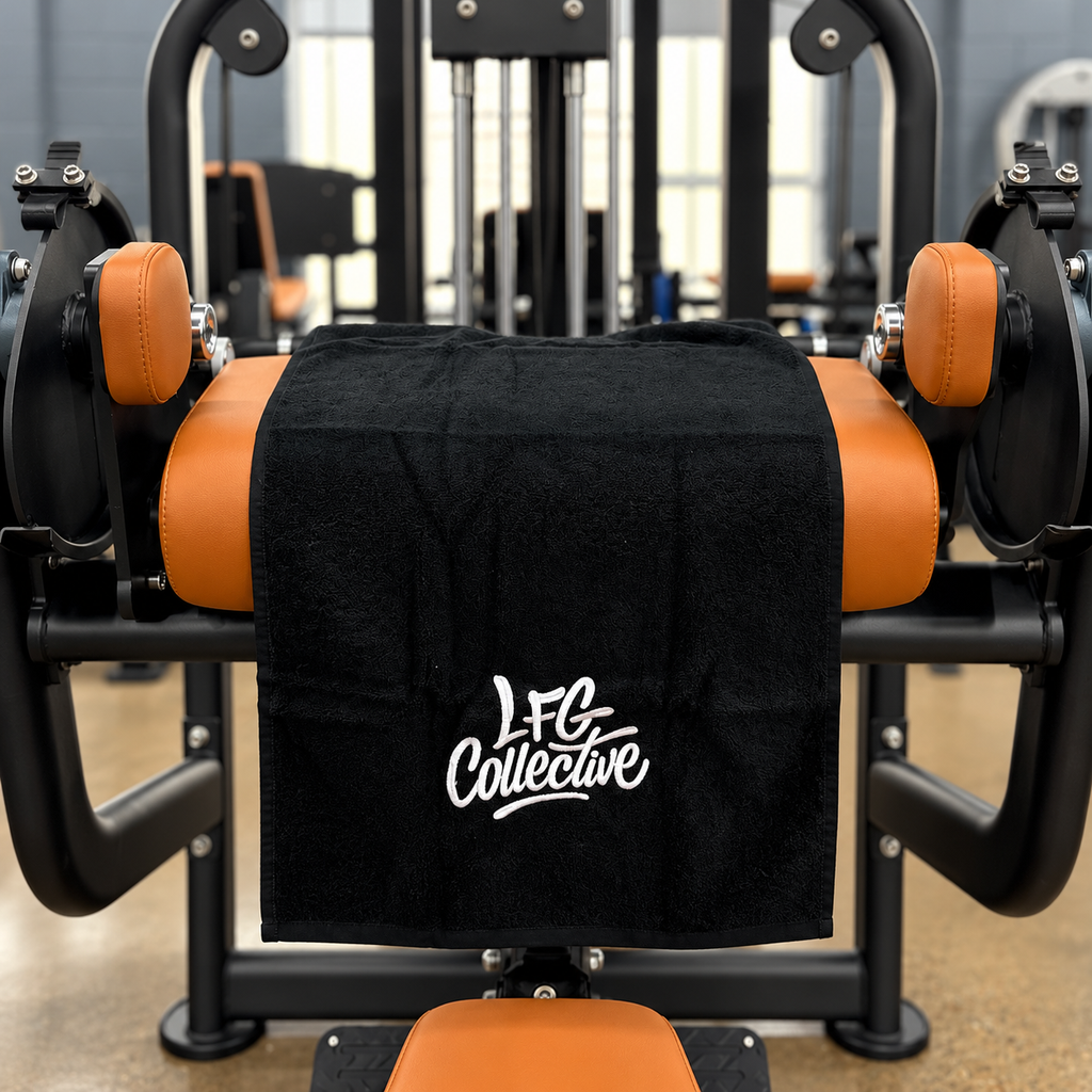 LFG Collective gym towel displayed on orange gym equipment