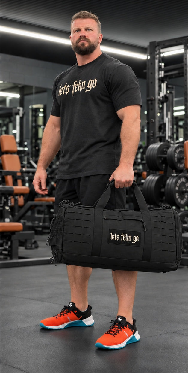 Jake with black duffel bag and LETS FCKN GO Velcro patch in the gym